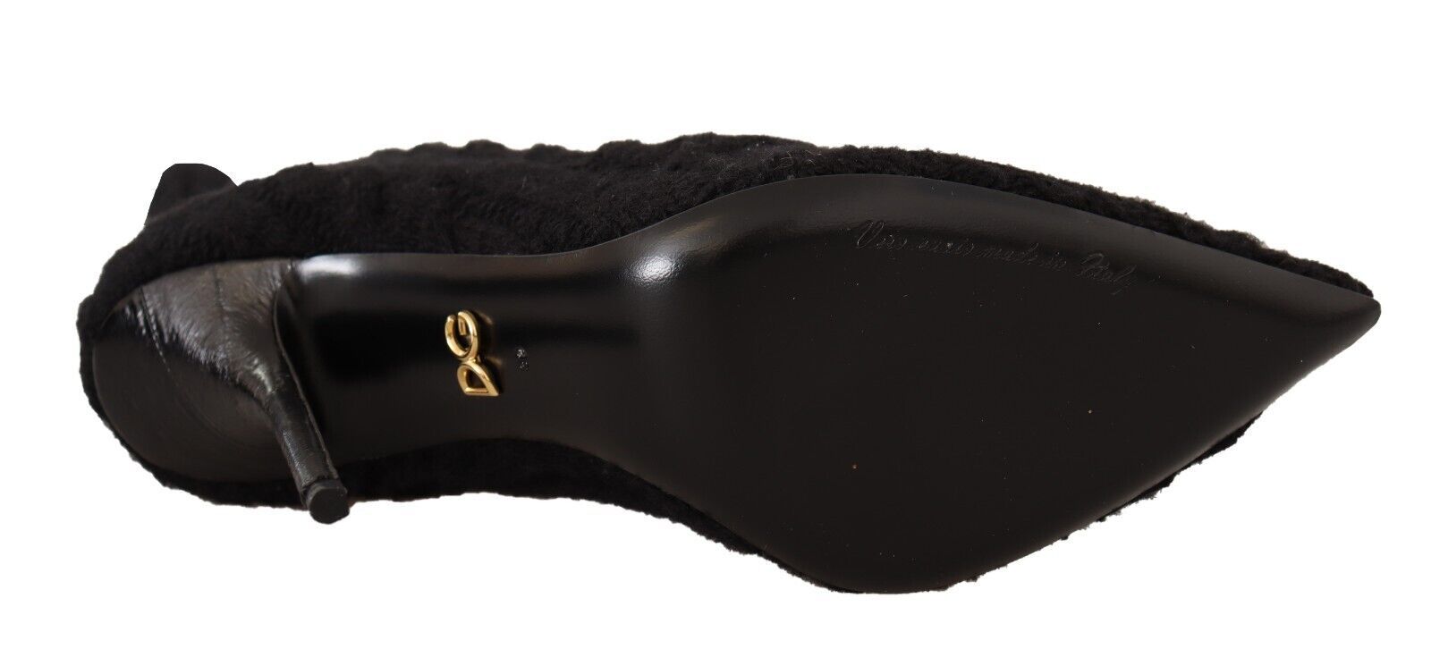a close up of a black shoe with a gold buckle